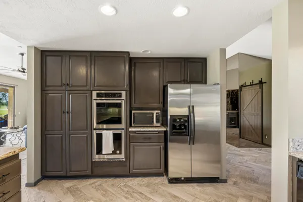 a kitchen with stainless steel appliances granite countertop a refrigerator and a sink