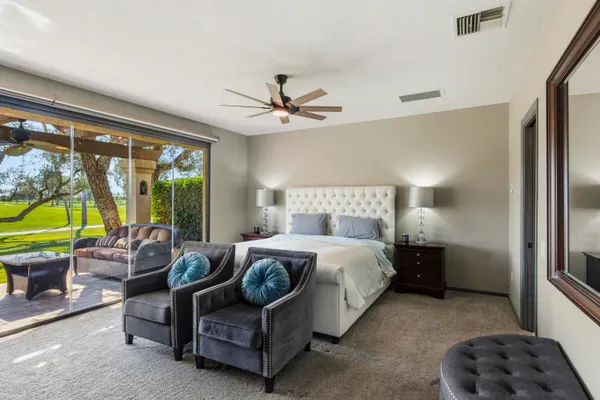 a bedroom with a bed and a couch