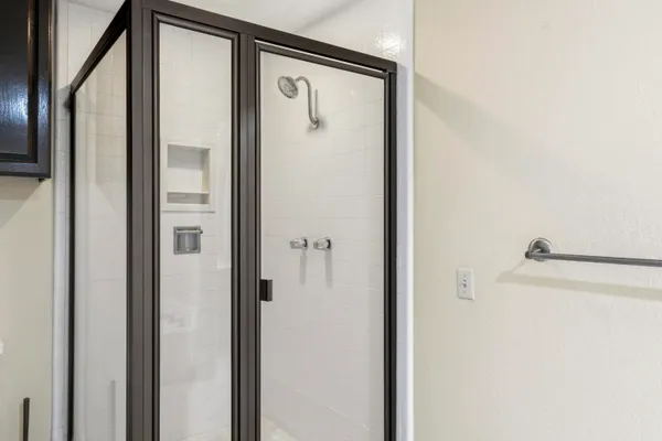 a bathroom with a shower and a mirror