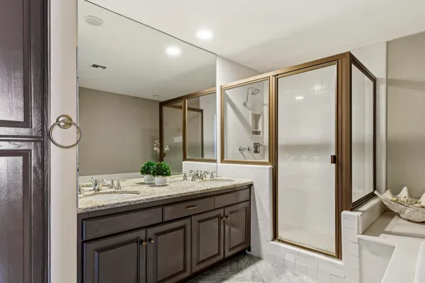 a bathroom with a double vanity sink and a mirror