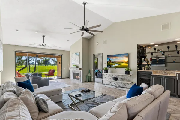 a living room with furniture a fireplace and a flat screen tv