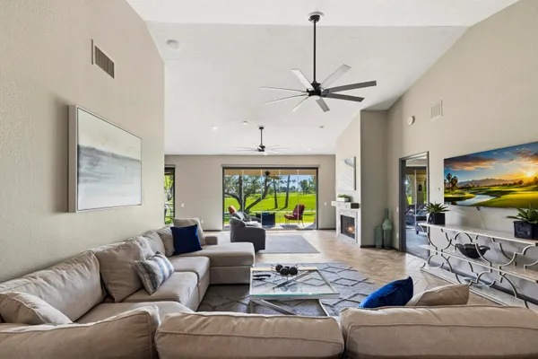a living room with furniture a window and a flat screen tv