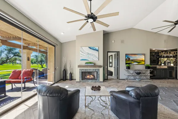 a living room with furniture a fireplace and a window