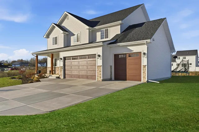 a front view of a house with garden