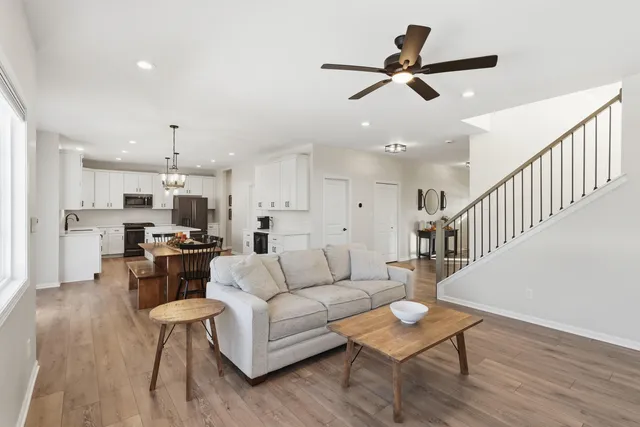 a living room with furniture kitchen view and a dining table