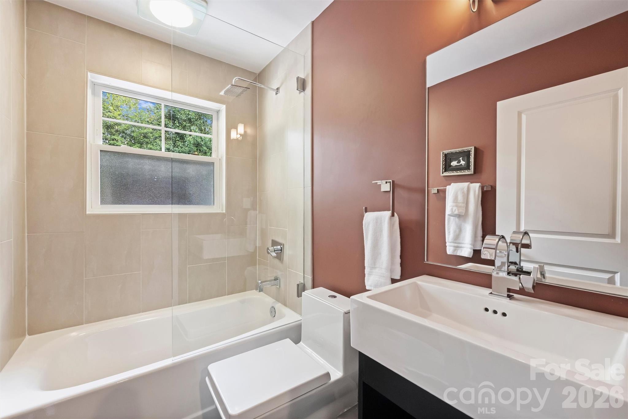 1734 Club Road Charlotte, NC 28205 - Photo 15 of 41 a bathroom with a tub a sink and a window
