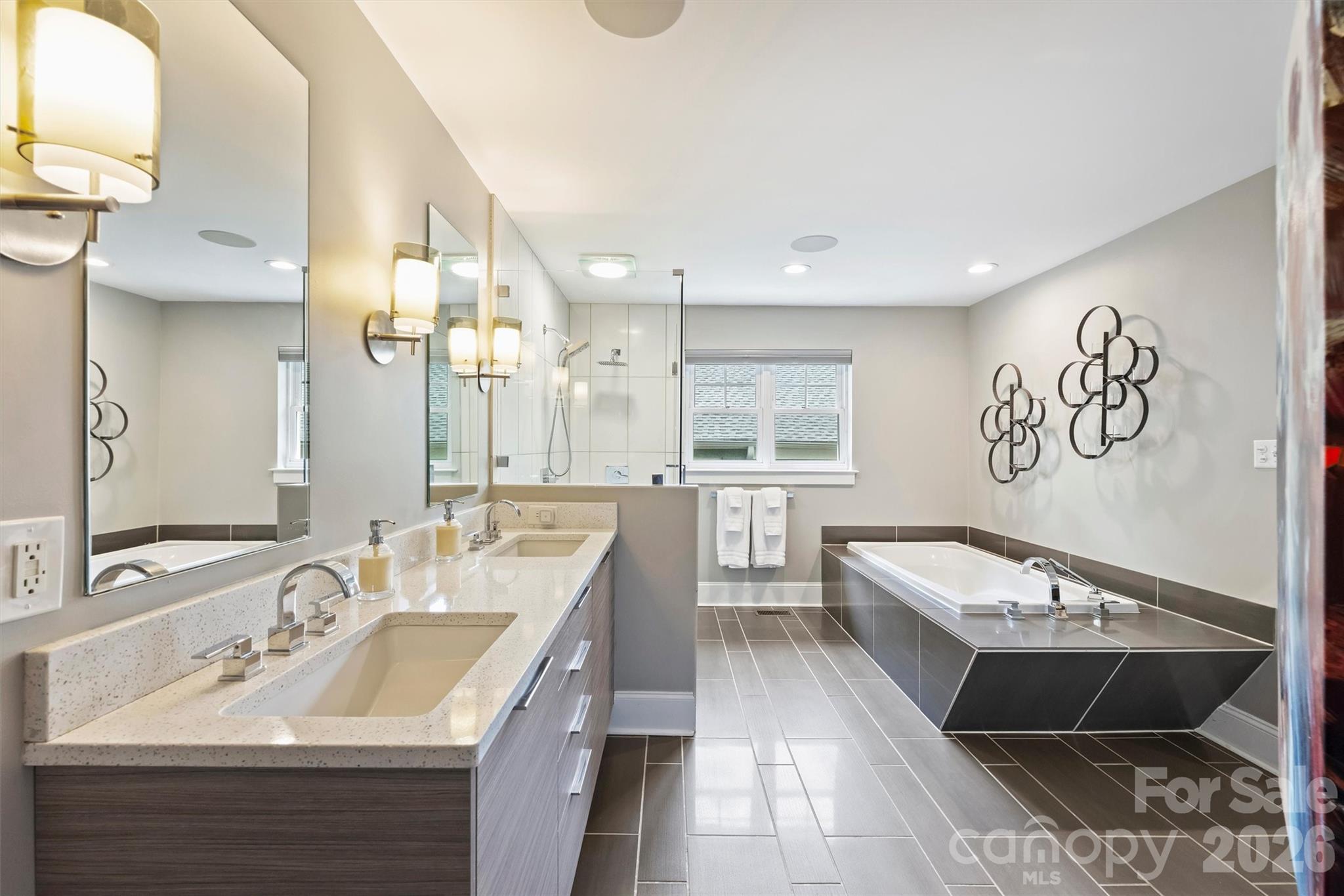 1734 Club Road Charlotte, NC 28205 - Photo 21 of 41 a en suite bathroom with a double vanity sink a mirror and a bathtub