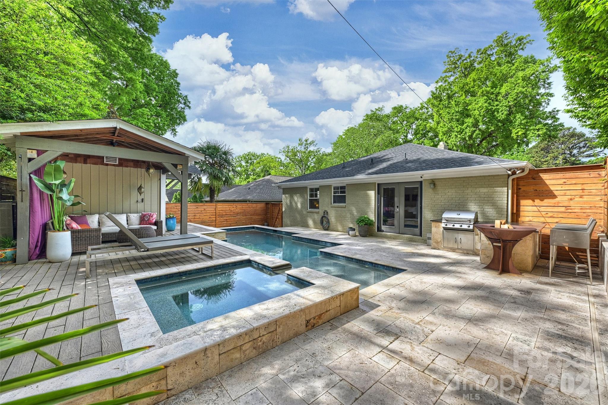 1734 Club Road Charlotte, NC 28205 - Photo 26 of 41 a view of a patio with table and chairs under an umbrella