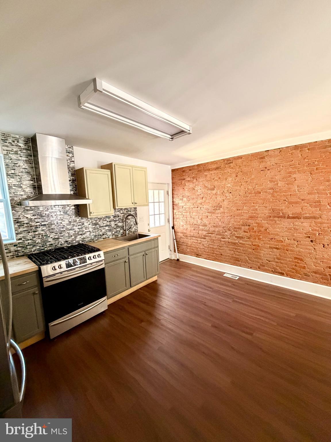 1944 Palethorp Street Philadelphia, PA 19122 - Photo 5 of 14 Unique brick wall in kitchen, updated lighting