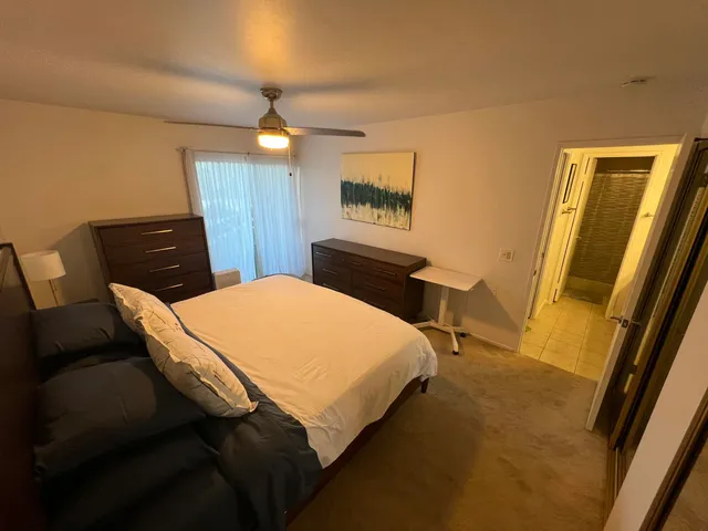 a bedroom with a bed and a mirror