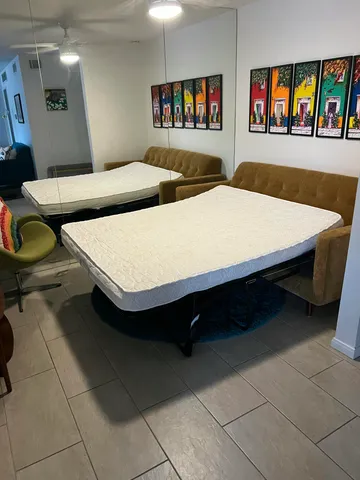 a spacious bedroom with a bed and a table in it