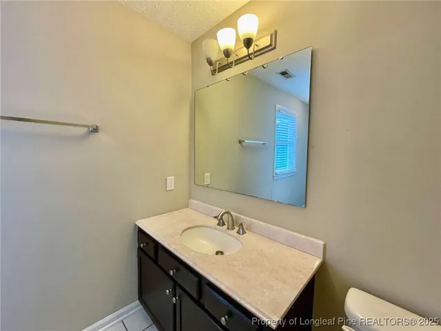 a bathroom with a sink vanity and a mirror