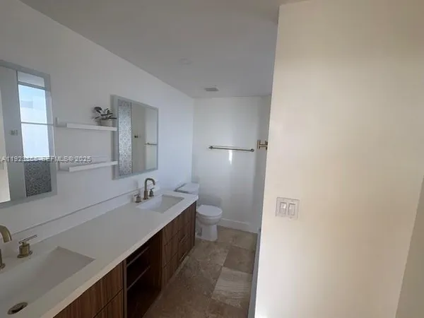 a bathroom with a double vanity sink a and mirror