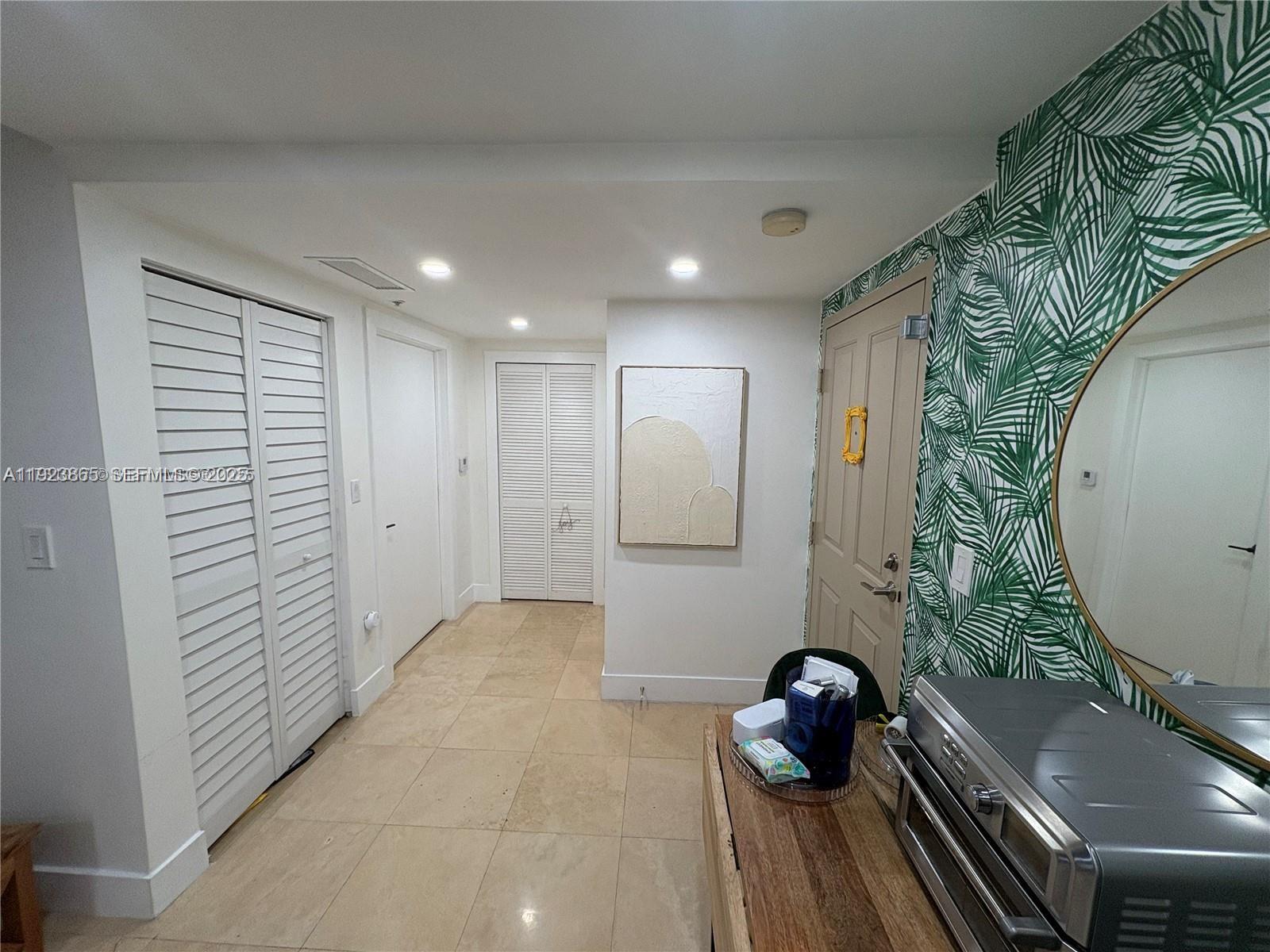 2650 Southwest 37th Avenue, Unit 807 Miami, FL 33134 - Photo 6 of 15 a bathroom with a sink and mirror