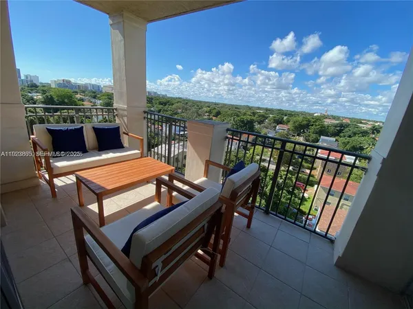 a view of a balcony with furniture