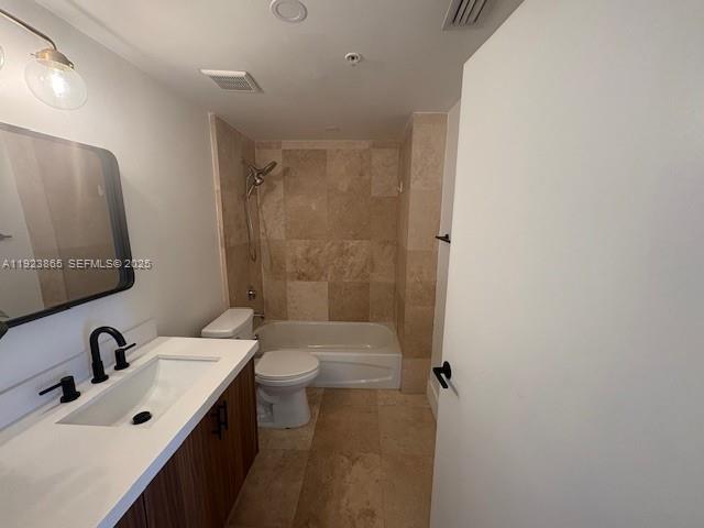 2650 Southwest 37th Avenue, Unit 807 Miami, FL 33134 - Photo 9 of 15 a bathroom with a sink mirror toilet and shower