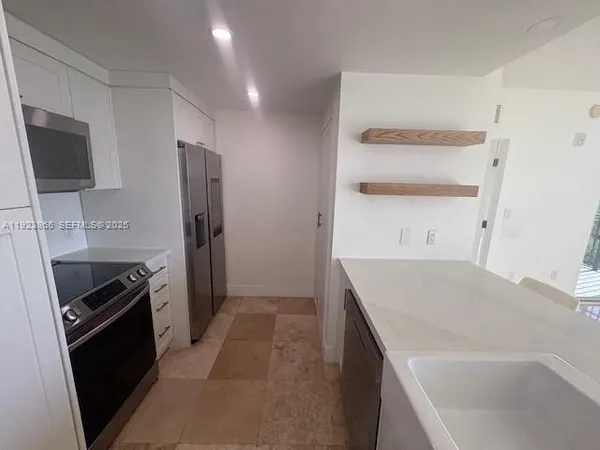 a kitchen with a sink stove and refrigerator