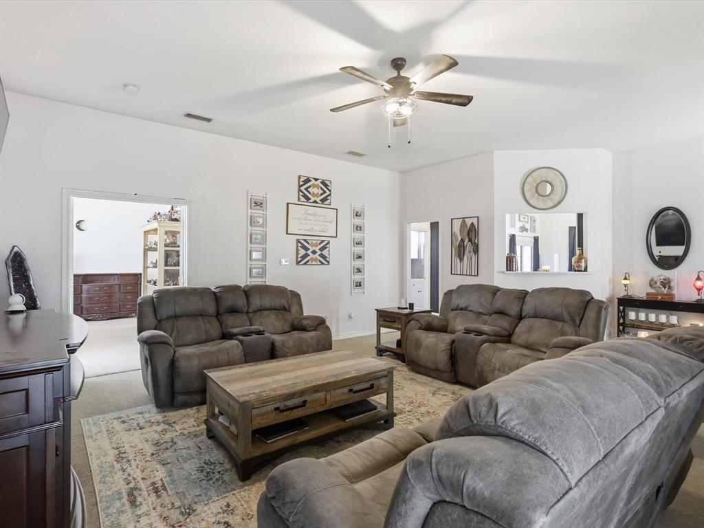 130 Parsonage Street Azle, TX 76020 - Photo 15 of 39 Carpeted living area featuring ceiling fan