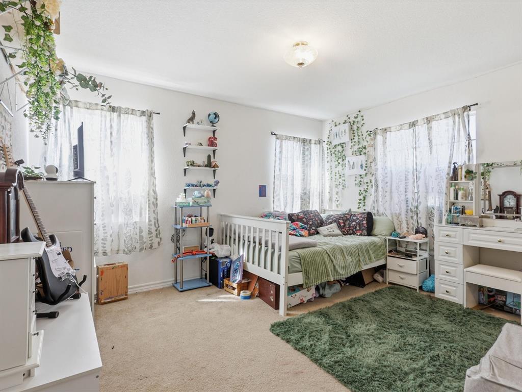 130 Parsonage Street Azle, TX 76020 - Photo 23 of 39 Bedroom with light colored carpet and baseboards