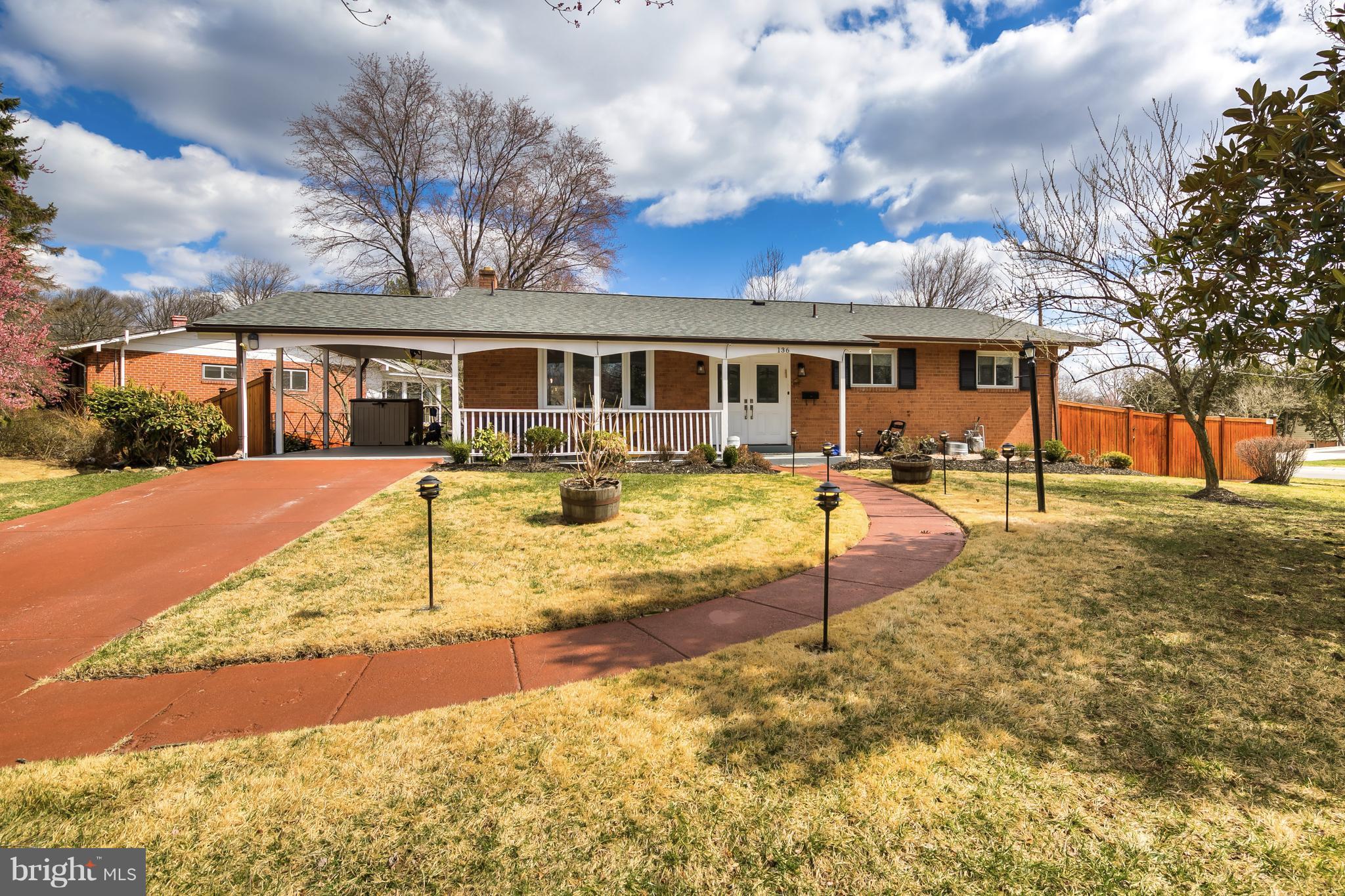 a view of a house with a yard patio and fire pit