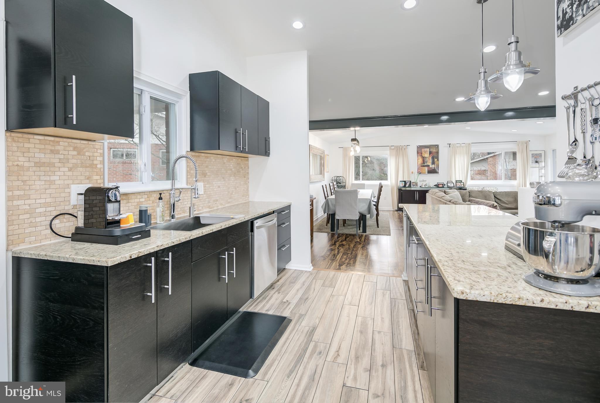136 Claybrook Drive Silver Spring, MD 20902 - Photo 11 of 30 a kitchen with granite countertop a sink stove and cabinets