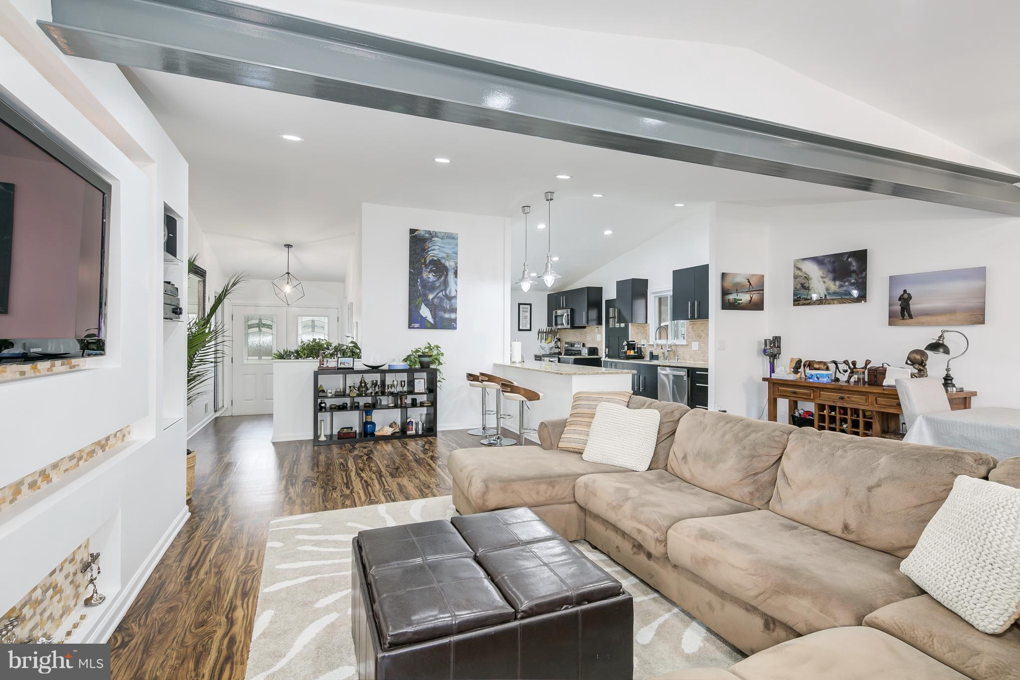 136 Claybrook Drive Silver Spring, MD 20902 - Photo 6 of 30 a living room with furniture kitchen view and a wooden floor