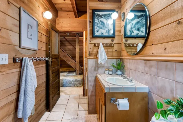 a utility room with stainless steel appliances lots of clutter and washer