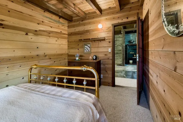 a bedroom with a bed and a mirror