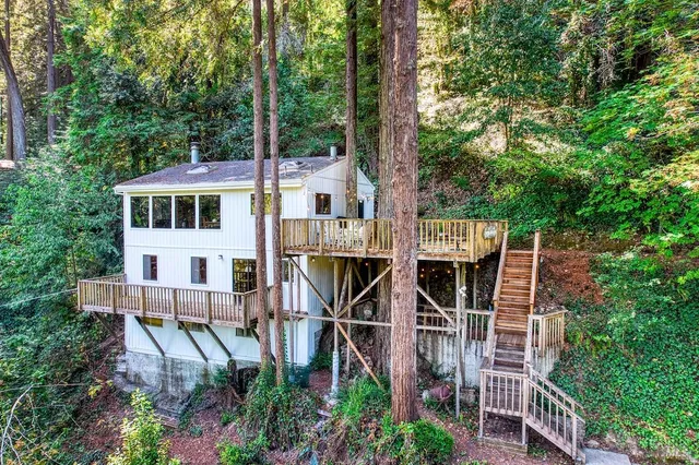 a view of a house with backyard and sitting area