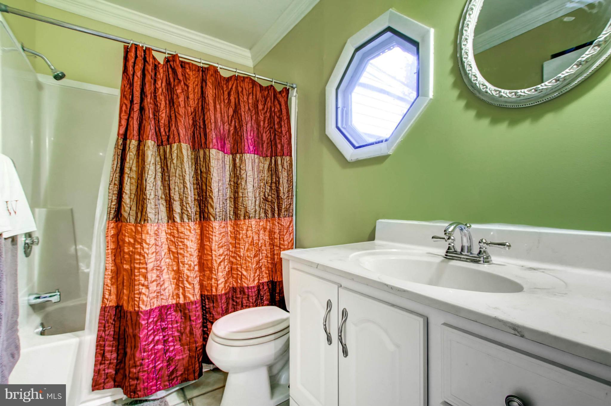 2911 Ridge Road Baltimore, MD 21244 - Photo 14 of 23 a bathroom with a sink and a mirror