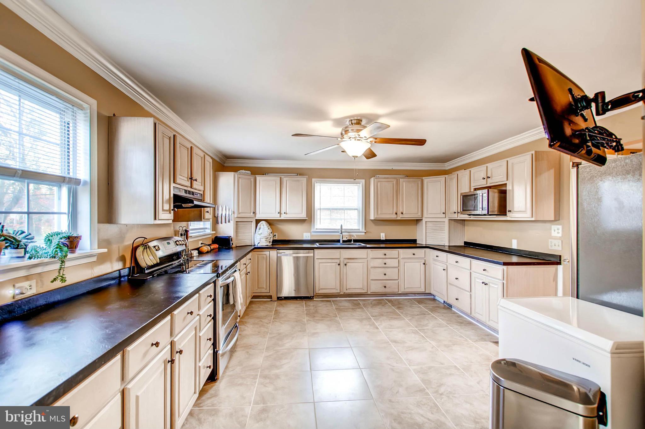 2911 Ridge Road Baltimore, MD 21244 - Photo 8 of 23 a large kitchen with stainless steel appliances granite countertop a sink and cabinets