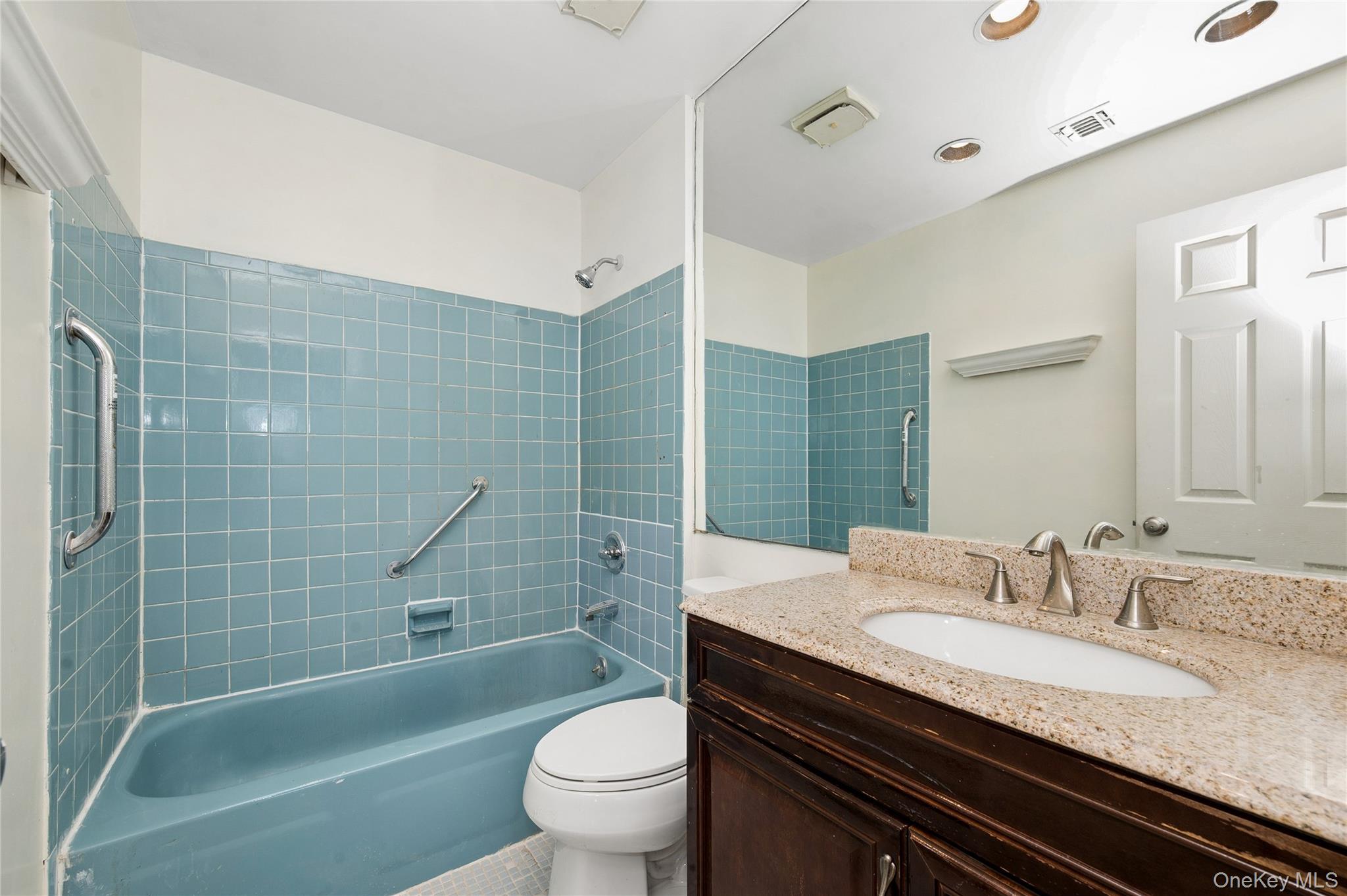 2625 Riverside Drive Wantagh, NY 11793 - Photo 20 of 20 a bathroom with a granite countertop toilet sink and mirror