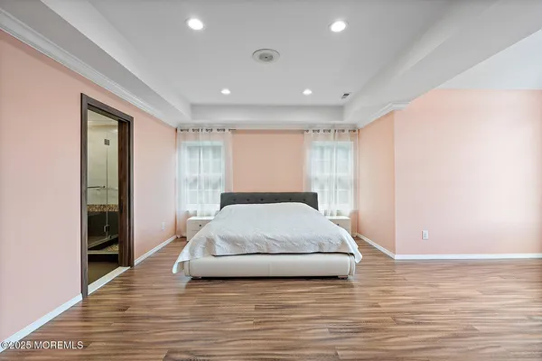 a spacious bedroom with a large bed and a large window