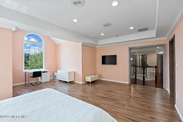 a room with wooden floor and windows