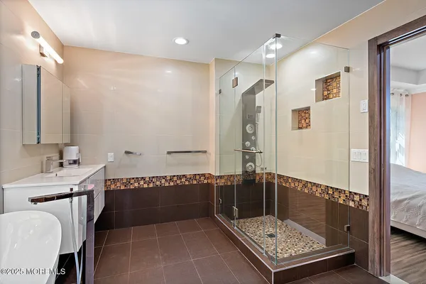 a bathroom with a tub a sink and a mirror