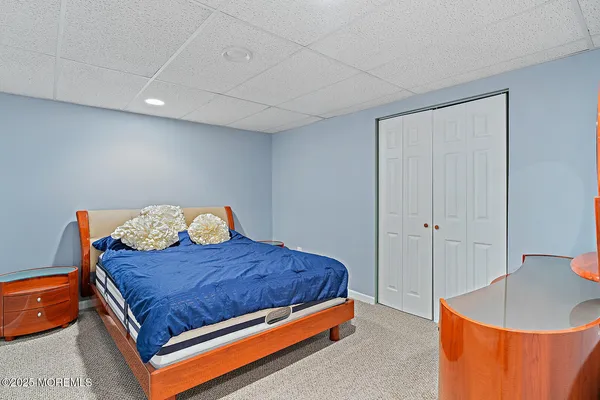 a bed sitting in a bedroom next to a bathroom