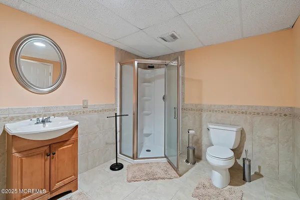 a bathroom with a toilet a sink and a mirror