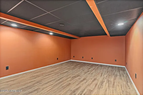 a view of room with wooden floor