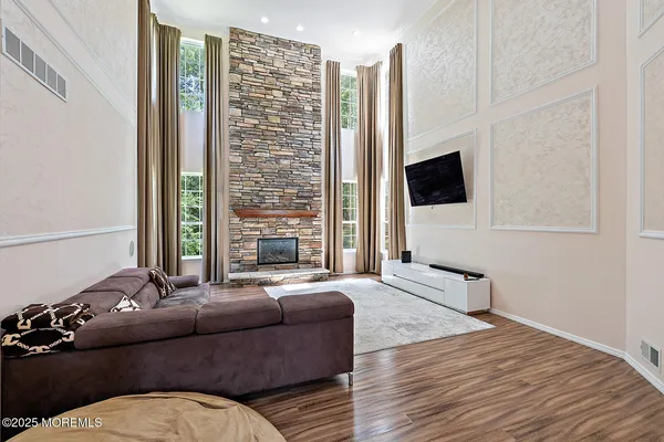 a living room with furniture fireplace and flat screen tv