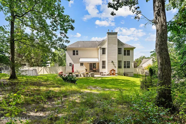 a view of a house with backyard and sitting area
