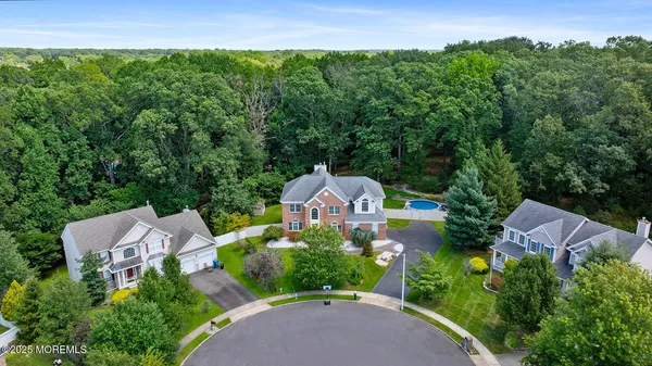 an aerial view of a house with a garden and a yard