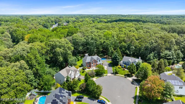 an aerial view of a house with a yard