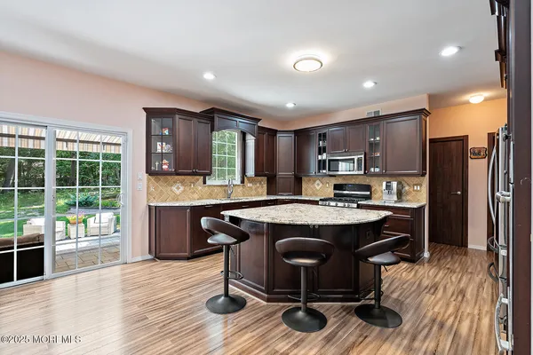 a kitchen with a table chairs refrigerator and cabinets