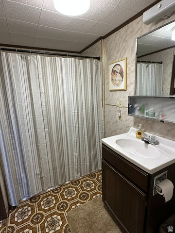1085 West Elk Road Helper, UT 84526 - Photo 14 of 40 Bathroom featuring patterned floor tiling and light-toned wall paneling