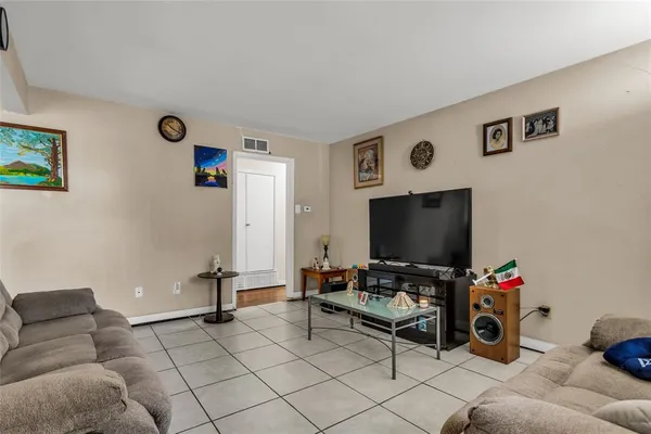 a living room with furniture a rug and a window