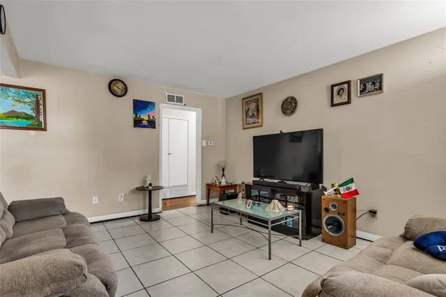 a living room with furniture a rug and a window
