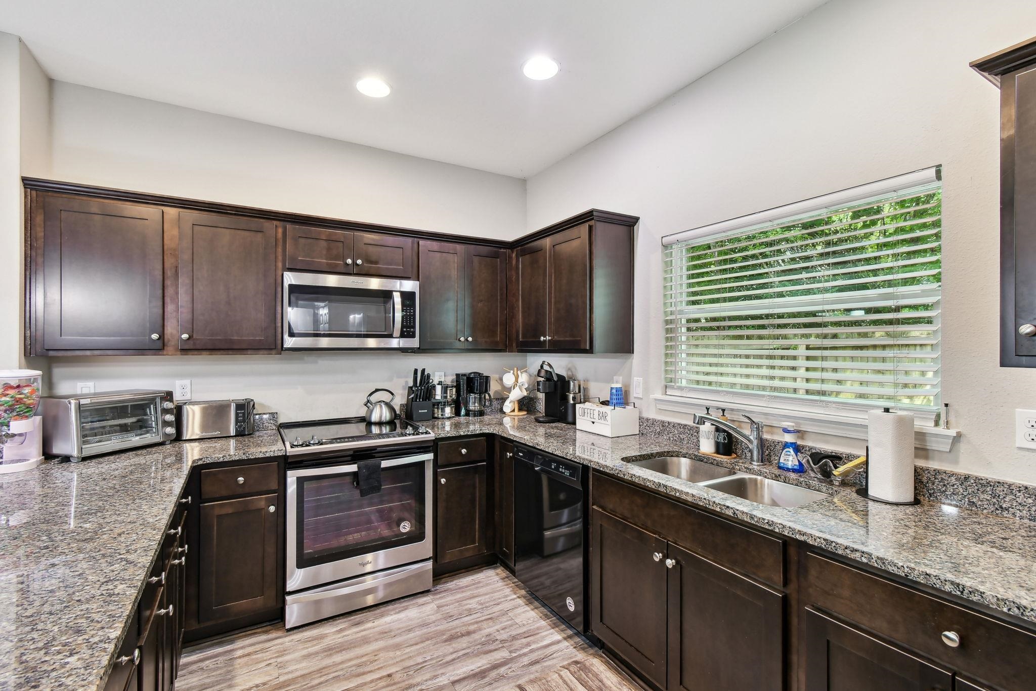 241 Columbus Street St. Augustine, FL 32084 - Photo 12 of 47 a kitchen with lots of counter top space a sink and appliances