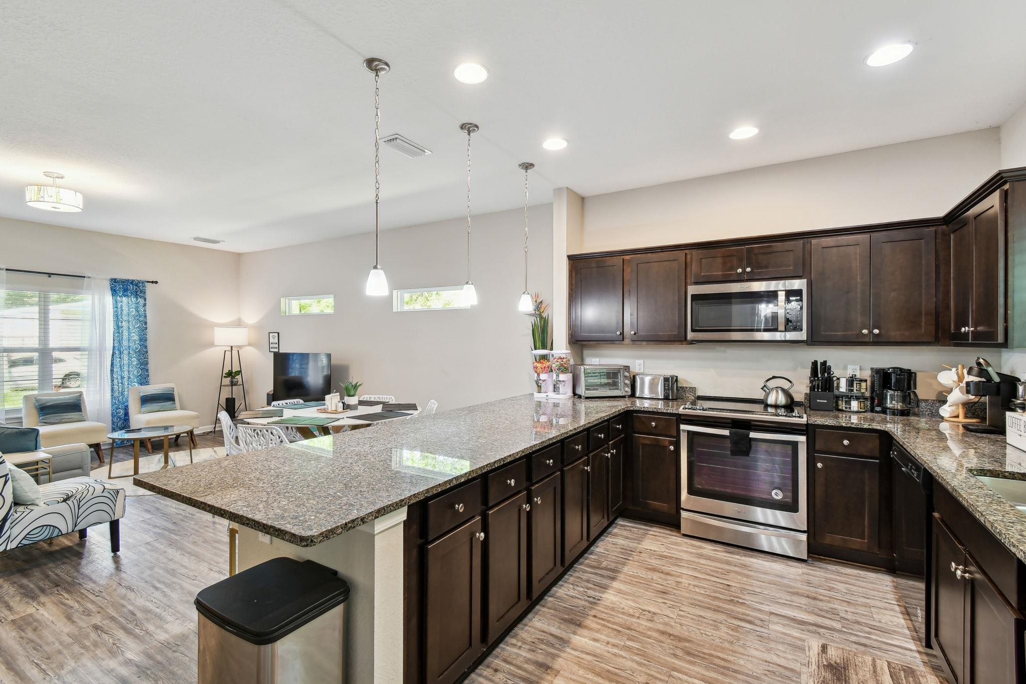 241 Columbus Street St. Augustine, FL 32084 - Photo 13 of 47 a kitchen with lots of counter space a sink and appliances