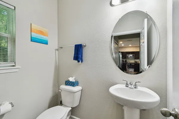 a bathroom with a toilet sink and mirror
