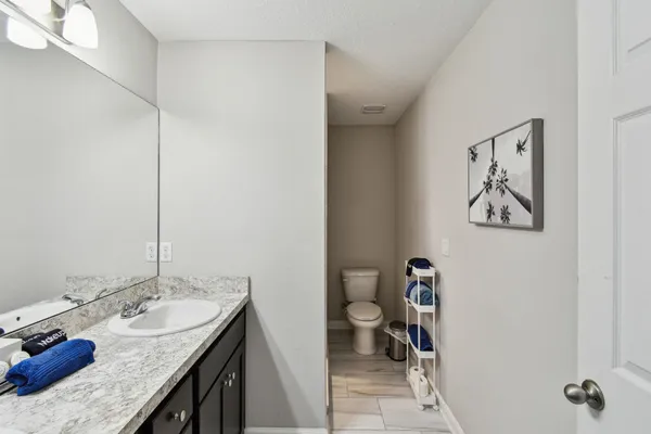 a bathroom with a granite countertop sink and a mirror